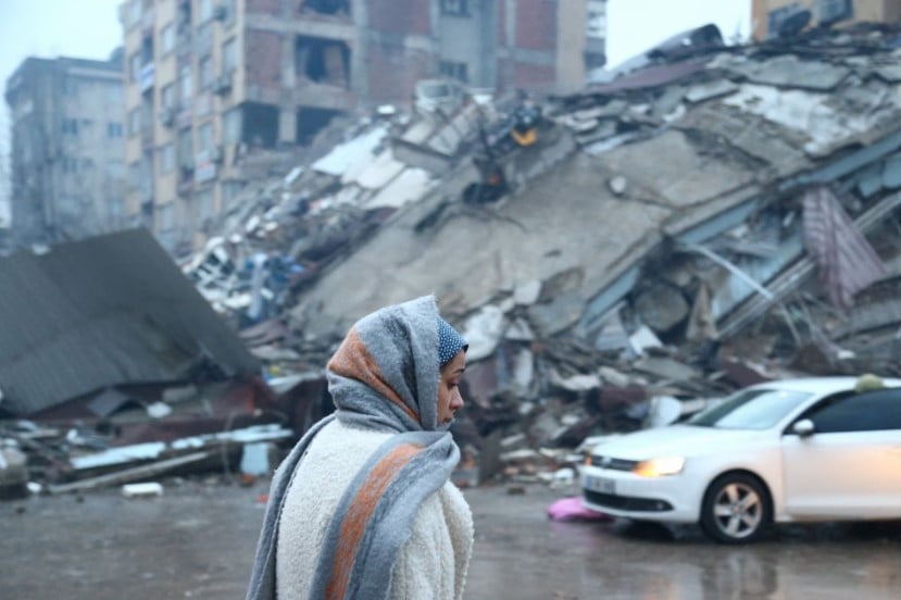 a woman stands near a collapsed building after an earthquake in kahramanmaras turkey february 6 2023 photo reuters