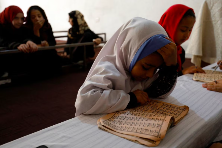 an afghan girl reads the koran in a madrasa or religious school in kabul afghanistan october 8 2022 photo reuters ali khara