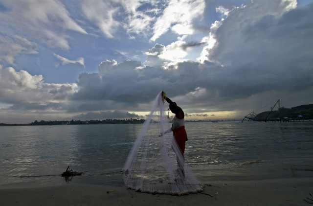 a fisherman arranges his fishing net at a beach against the backdrop of pre monsoon clouds in the southern indian city of kochi june 5 2014 photo reuters file a fisherman arranges his fishing net at a beach against the backdrop of pre monsoon clouds in the southern indian city of kochi june 5 2014 photo reuters file