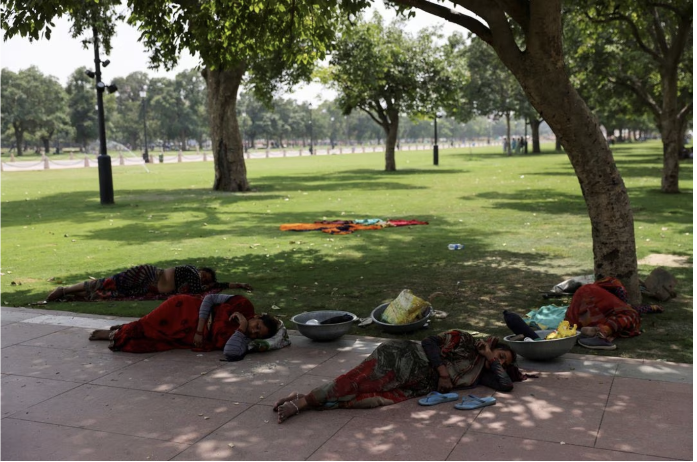 women labourers rest under a tree on a hot summer day near india gate in new delhi india may 15 2023 reuters file