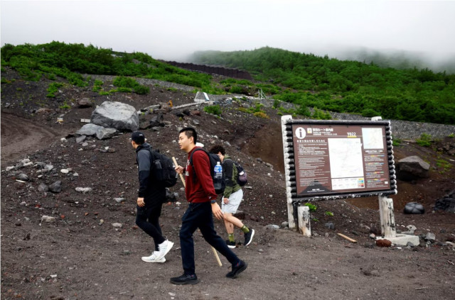 climbers walk on fuji yoshidaguchi trail yoshida route on the first day of the climbing season on the slopes of mount fuji in fujiyoshida yamanashi prefecture photo reuters climbers walk on fuji yoshidaguchi trail yoshida route on the first day of the climbing season on the slopes of mount fuji in fujiyoshida yamanashi prefecture photo reuters