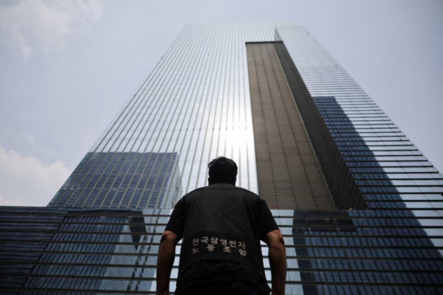 son woo mok president of national samsung electronics union looks up at the company building while staging a walkout protest in seoul south korea photo reuters son woo mok president of national samsung electronics union looks up at the company building while staging a walkout protest in seoul south korea photo reuters