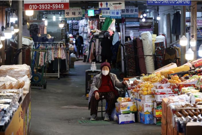 a shopkeeper naps as she waits for customers at a traditional market in seoul south korea photo reuters