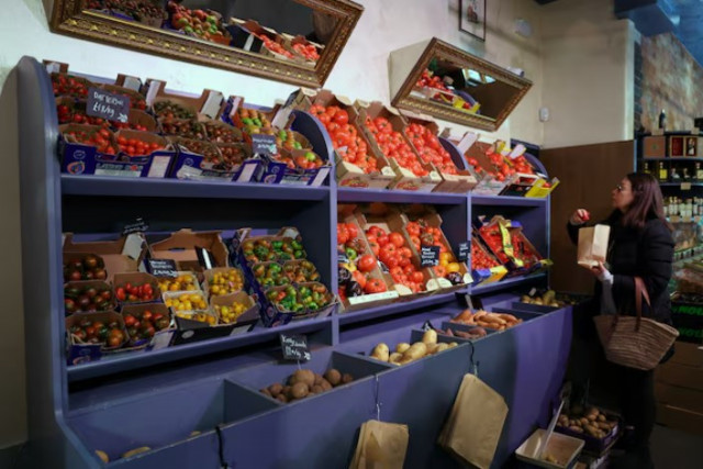 a customer shops for vegetables at gourmet grocery store andreas in london britain photo reuters a customer shops for vegetables at gourmet grocery store andreas in london britain photo reuters