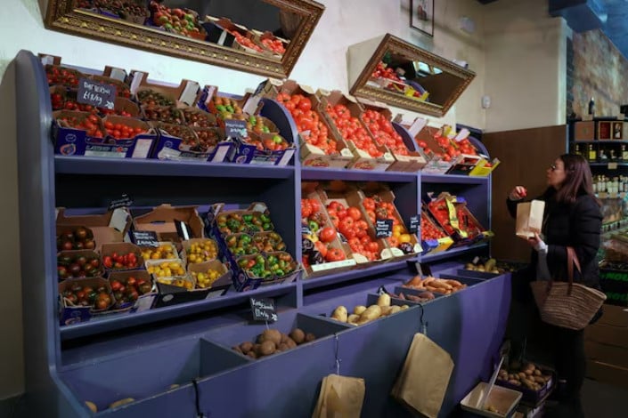 a customer shops for vegetables at gourmet grocery store andreas in london britain photo reuters
