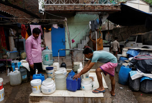 residents fill their containers from a tap that dispenses water twice a day at a slum in new delhi india photo reuters residents fill their containers from a tap that dispenses water twice a day at a slum in new delhi india photo reuters