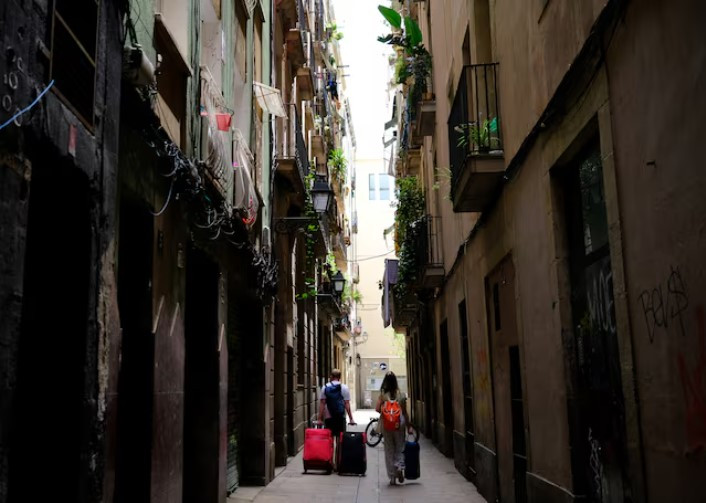 tourists walk with their suitcases in gothic quarter in barcelona spain photo reuters