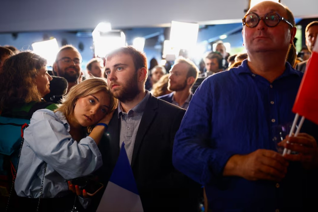 supporters of the french far right rassemblement national national rally   rn party react after partial results in the second round of the early french parliamentary elections at the rn in paris france photo reuters