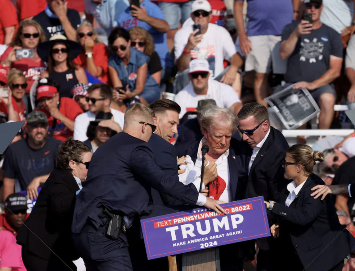 republican presidential candidate and former u s president donald trump is assisted by u s secret service personnel after gunfire rang out during a campaign rally at the butler farm show in butler pennsylvania us july 13 2024 photo reuters
