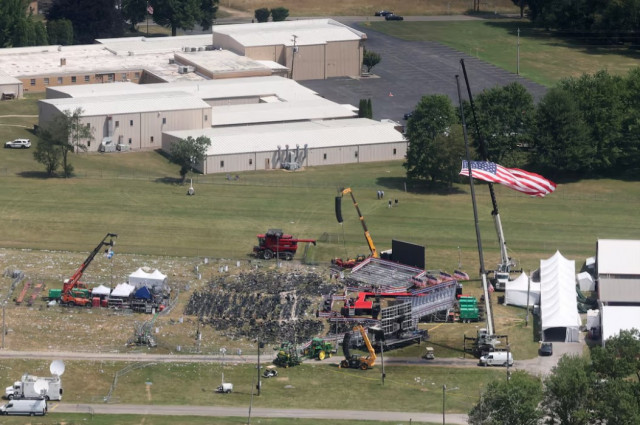 an aerial view shows the stage where republican presidential candidate and former u s president donald trump had been standing during an assassination attempt the day before and the roof of a nearby building where a gunman was shot dead by law enforcement in butler pennsylvania us photo reuters an aerial view shows the stage where republican presidential candidate and former u s president donald trump had been standing during an assassination attempt the day before and the roof of a nearby building where a gunman was shot dead by law enforcement in butler pennsylvania us photo reuters