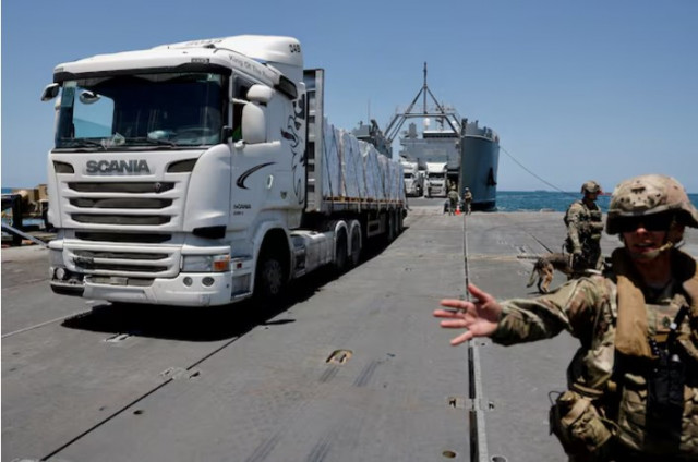 a truck carries humanitarian aid across trident pier a temporary pier to deliver aid off the gaza strip amid the ongoing conflict between israel and hamas near the gaza coast photo reuters a truck carries humanitarian aid across trident pier a temporary pier to deliver aid off the gaza strip amid the ongoing conflict between israel and hamas near the gaza coast photo reuters