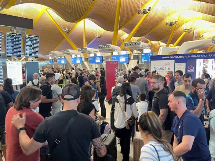 passengers wait at barajas airport as spanish airport operator aena on friday reported a computer systems incident at all spanish airports which may cause flight delays in madrid spain photo reuters