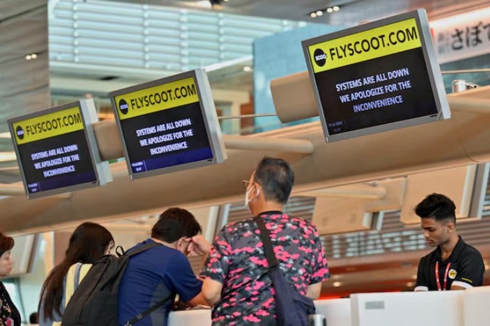 scoot passengers wait to be checked in manually at changi airport terminal 1 in singapore after a global it system outage photo reuters