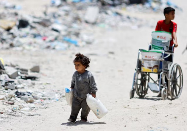 a palestinian girl carries cans to collect water as she walks by houses which were destroyed in an israeli strike amid the ongoing conflict between israel and hamas in khan younis in the southern gaza strip photo reuters a palestinian girl carries cans to collect water as she walks by houses which were destroyed in an israeli strike amid the ongoing conflict between israel and hamas in khan younis in the southern gaza strip photo reuters