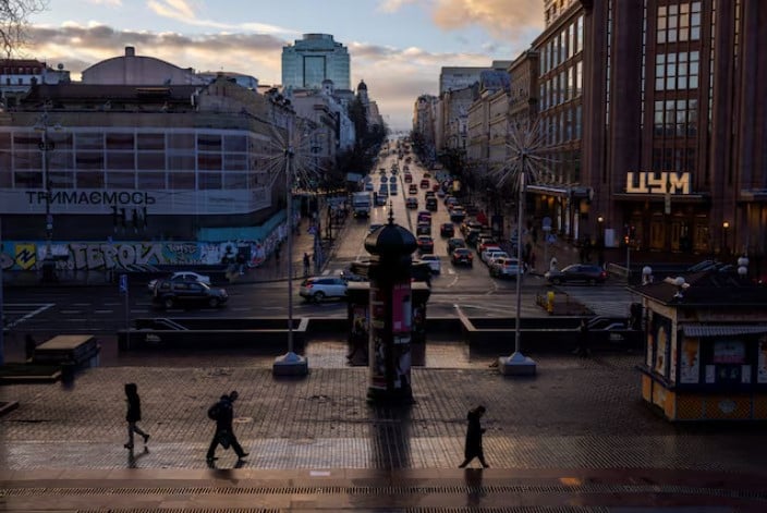 people walk along khreshchatyk street as the evening sun breaks through the clouds after a rainy day in kyiv amid russia s attack on ukraine photo reuters