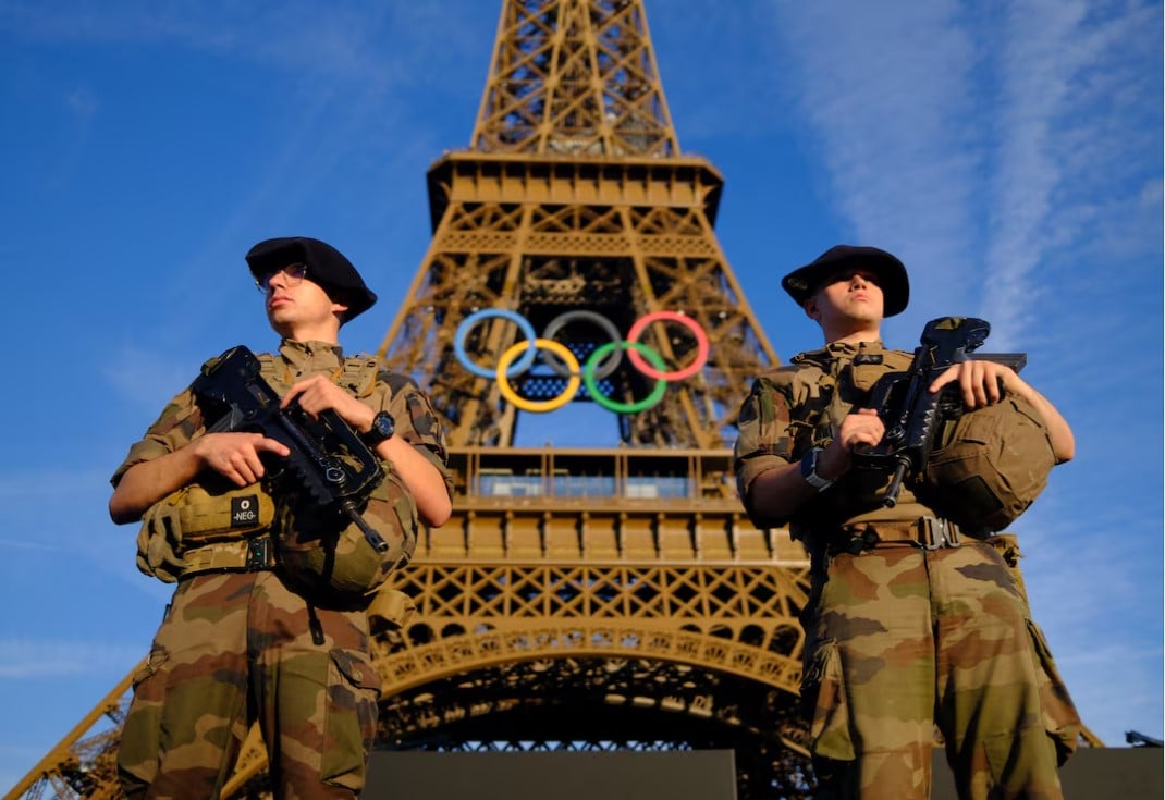 paris 2024 olympics   paris 2024 olympics preview   paris france   july 21 2024 soldiers patrol on a street in front of the eiffel tower ahead of the olympics photo reuters