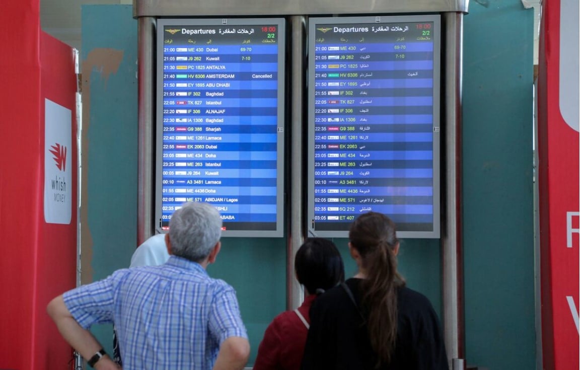 people look at flight information boards at the beirut rafic hariri international airport in beirut lebanon photo reuters