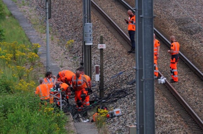 sncf railway workers and law enforcement officers work at the site where vandals targeted france s high speed train network with a series of coordinated actions that brought major disruption ahead of the paris 2024 olympics opening ceremony in croisilles northern france photo reuters