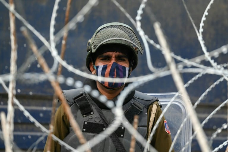 A security officer stands guard at a road block. PHOTO: AFP