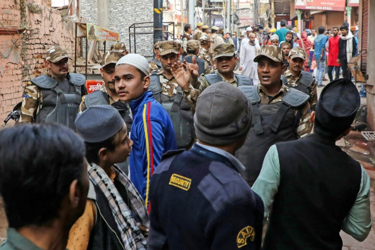 Security personnel patrol along a street near the Gyanvapi mosque in Varanasi.  PHOTO: AFP