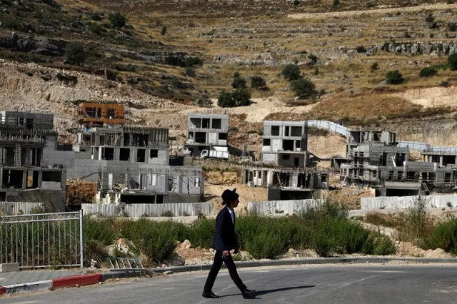 a jewish settler walks past israeli settlement construction sites around givat zeev and ramat givat zeev in the israeli occupied west bank near jerusalem june 30 2020 photo reuters a jewish settler walks past israeli settlement construction sites around givat zeev and ramat givat zeev in the israeli occupied west bank near jerusalem june 30 2020 photo reuters
