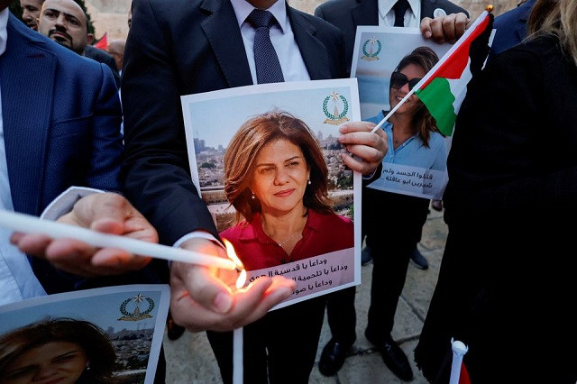 people light candles during a vigil in memory of al jazeera journalist shireen abu akleh who was killed during an israeli raid outside the church of the nativity in bethlehem in the israeli occupied west bank may 16 2022 photo reuters