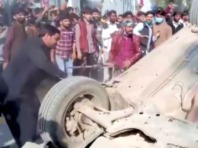 a mob hits an overturned car with sticks after an attack on a factory in sialkot pakistan december 3 2021 in this screen grab taken from a video photo reuters a mob hits an overturned car with sticks after an attack on a factory in sialkot pakistan december 3 2021 in this screen grab taken from a video photo reuters