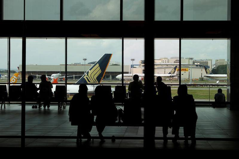 people look at a singapore airlines plane amid the spread of the coronavirus disease covid 19 at a viewing gallery of the changi airport in singapore photo reuters