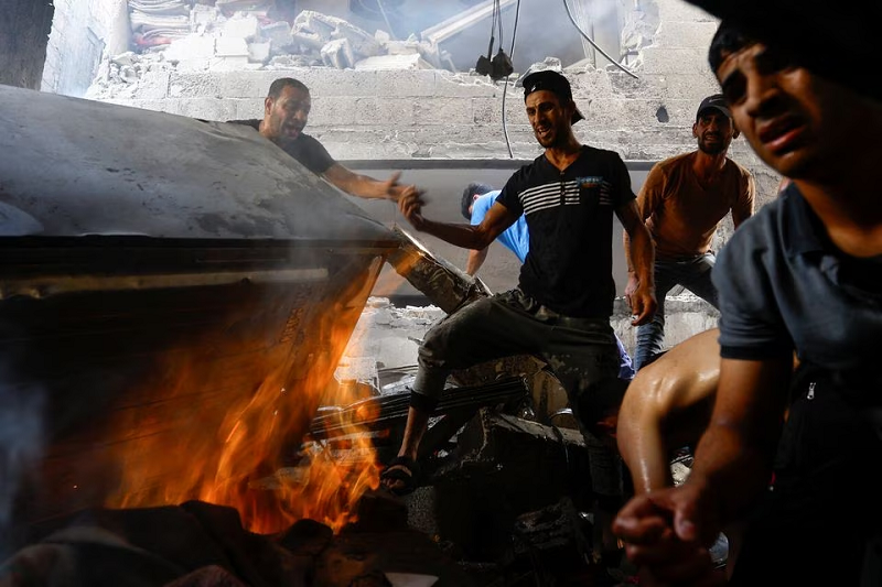 palestinians search for casualties at the site of an israeli strike on a house in khan younis in the southern gaza strip october 24 photo reuters