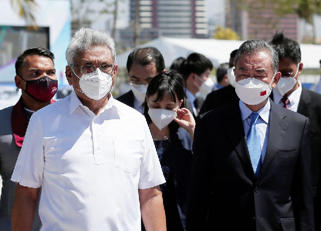 chinese foreign minister wang yi arrives with sri lanka s president gotabaya rajapaksa and sri lanka s sports minister namal rajapaksa during his visit to colombo port city project in colombo sri lanka january 9 2022 photo reuters chinese foreign minister wang yi arrives with sri lanka s president gotabaya rajapaksa and sri lanka s sports minister namal rajapaksa during his visit to colombo port city project in colombo sri lanka january 9 2022 photo reuters