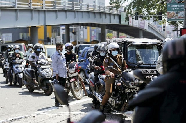 vehicle owners wait in line to fill their tanks during a power outage at a ceylon petroleum corporation fuel station in nugegoda colombo sri lanka february 24 2022 photo reuters