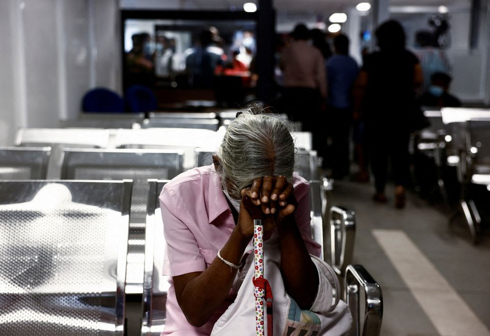 a woman waits to apply for a passport at the sri lanka s immigration and emigration department amid the country s economic crisis in colombo sri lanka june 8 2022 photo reuters