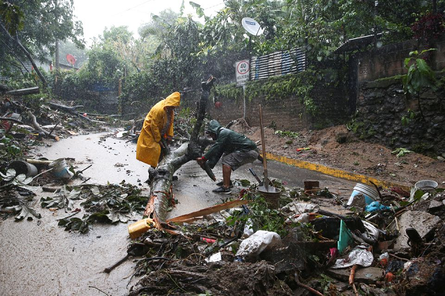 residents clean a mudslide in a road while tropical storm julia hits with wind and rain in san salvador el salvador october 10 2022 photo reuters