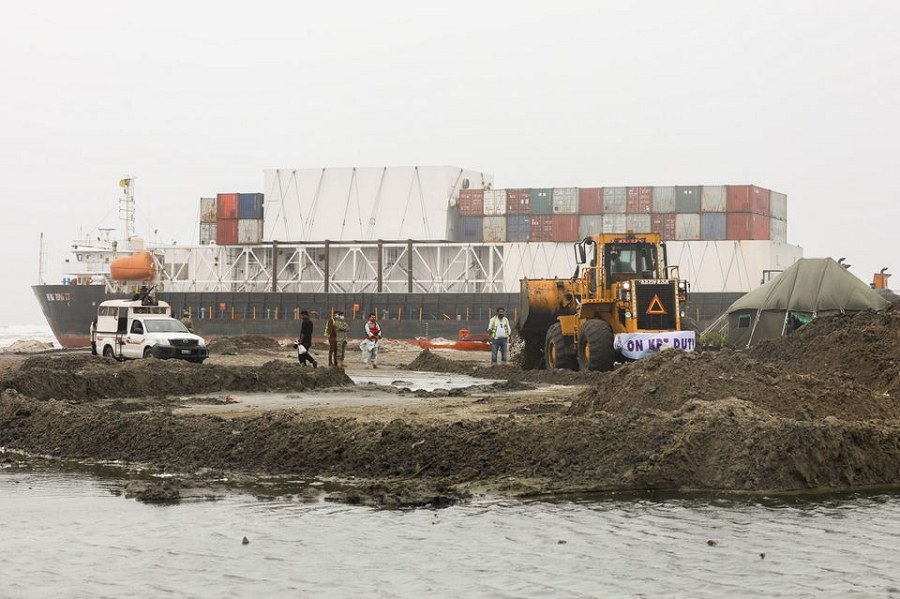 A wheel loader clears the ground near stranded cargo ship MV Heng Tong 77 at Sea View beach in Karachi. PHOTO: REUTERS