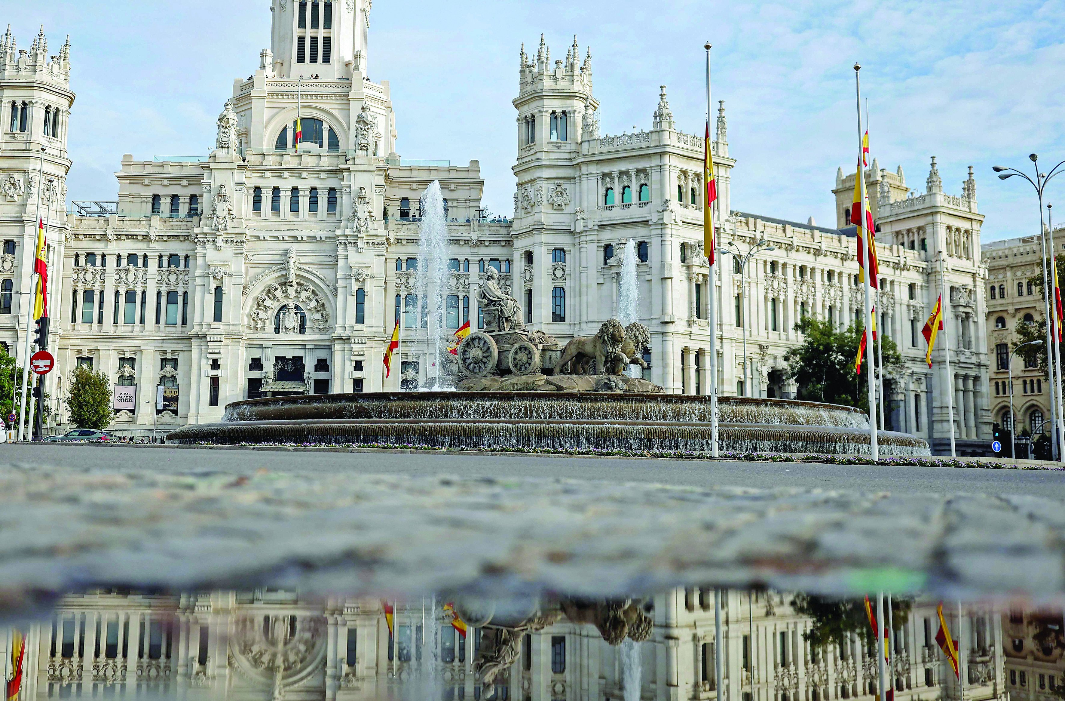 spanish flags fly at half mast at the start of three days of national mourning at cibeles square in madrid photo afp