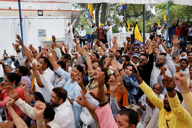 Supporters cheer during a press conference by Delhi Chief Minister Arvind Kejriwal at the Aam Admi Party headquarters after India's Supreme Court gave temporary bail to the AAP national conveyor in a liquor policy case, in New Delhi, India, May 11, 2024. PHOTO: REUTERS