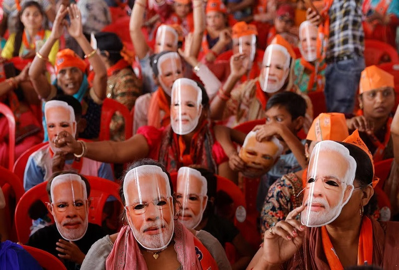 supporters of india s pmmodi wear masks of his face as they attend an election campaign rally in meerut india march 31 2024 photo reuters