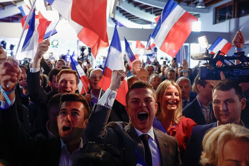 Supporters of the French far-right National Rally (Rassemblement National - RN) party react after the polls closed during the European Parliament elections, in Paris, France, June 9, 2024. PHOTO: REUTERS