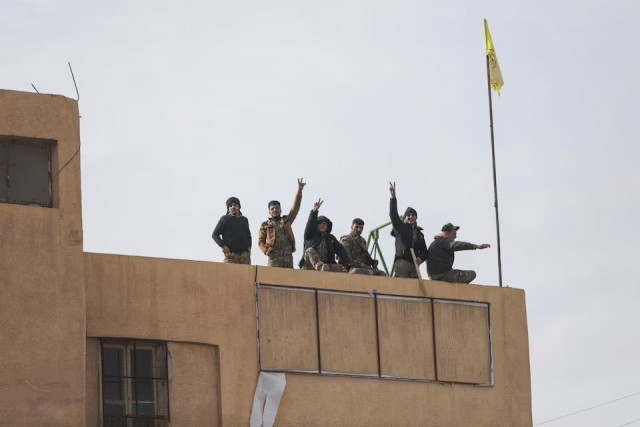 members of the kurdish led syrian democratic forces sdf gesture in deir al zor the government s main foothold in the vast desert according to syrian sources in syria on december 7 2024 photo reuters members of the kurdish led syrian democratic forces sdf gesture in deir al zor the government s main foothold in the vast desert according to syrian sources in syria on december 7 2024 photo reuters