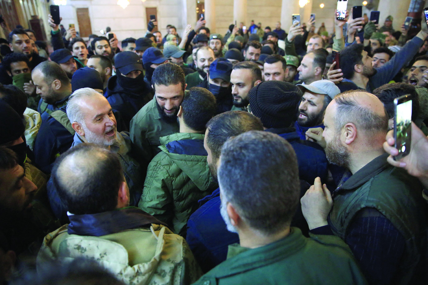 new beginning people greet abu mohammed al jolani the leader of syria s hts group in the umayyad mosque after the rebels seized damascus from government control photo afp