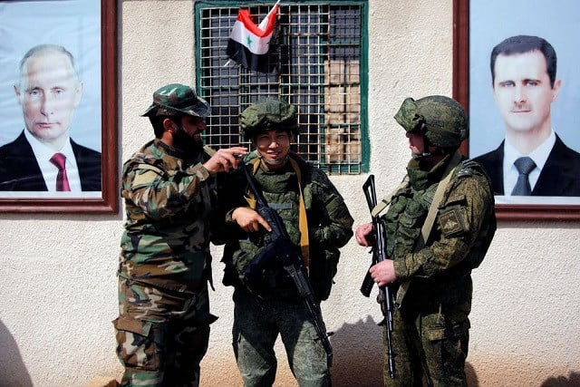 syrian and russian soldiers are seen at a checkpoint near wafideen camp in damascus syria march 2 2018 photo reuters syrian and russian soldiers are seen at a checkpoint near wafideen camp in damascus syria march 2 2018 photo reuters