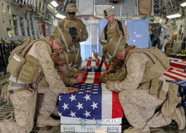 us marines honor their fallen service members killed in action during a ramp ceremony at hamid karzai international airport in kabul afghanistan august 27 2021 picture taken august 27 2021 us central command handout via reuters us marines honor their fallen service members killed in action during a ramp ceremony at hamid karzai international airport in kabul afghanistan august 27 2021 picture taken august 27 2021 us central command handout via reuters