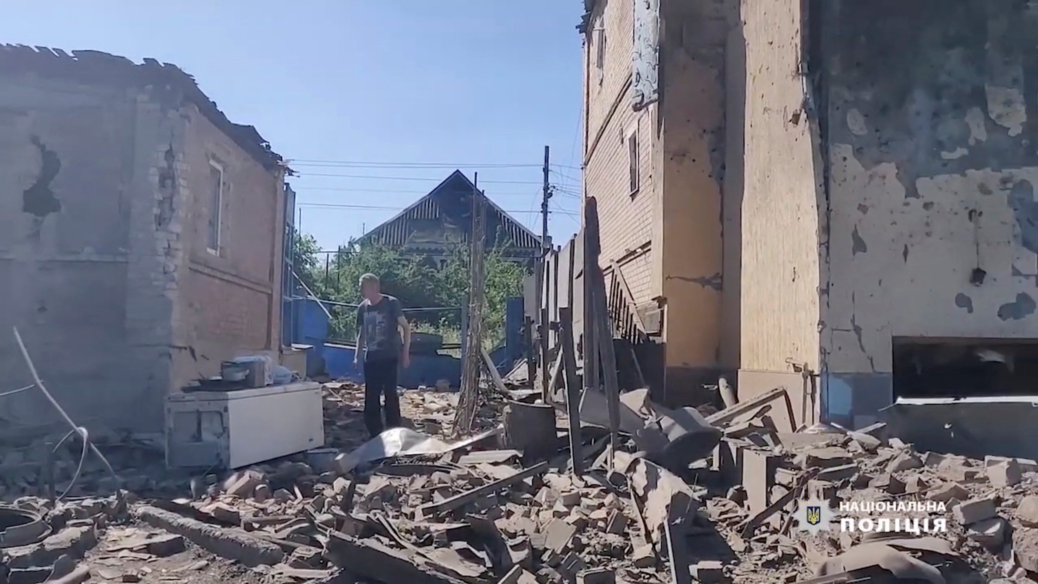 a man walks in the rubble near damaged buildings as russia s invasion of ukraine continues in bakhmut donetsk oblast ukraine photo national police of ukraine handout via reuters