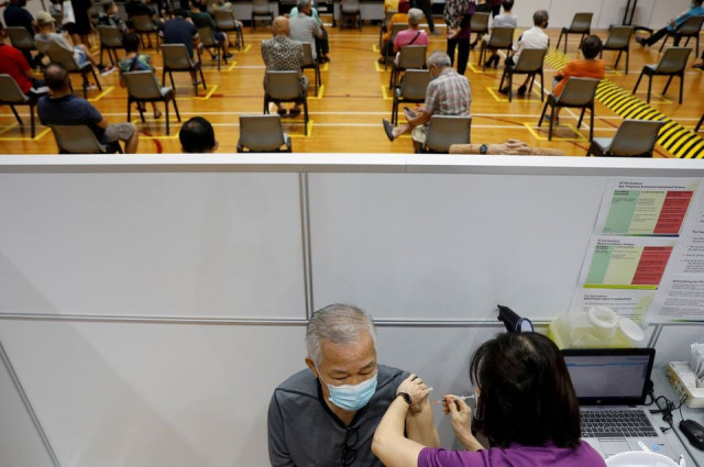 a man receives his vaccination at a coronavirus disease covid 19 vaccination center in singapore march 8 2021 photo reuters a man receives his vaccination at a coronavirus disease covid 19 vaccination center in singapore march 8 2021 photo reuters