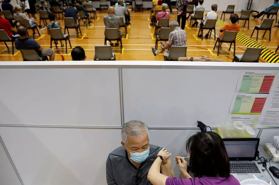 a man receives his vaccination at a coronavirus disease covid 19 vaccination center in singapore march 8 2021 photo reuters a man receives his vaccination at a coronavirus disease covid 19 vaccination center in singapore march 8 2021 photo reuters