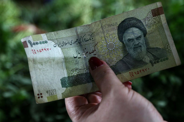 a woman holds an iranian currency in tajrish bazaar in tehran iran august 1 2019 nazanin tabatabaee wana a woman holds an iranian currency in tajrish bazaar in tehran iran august 1 2019 nazanin tabatabaee wana