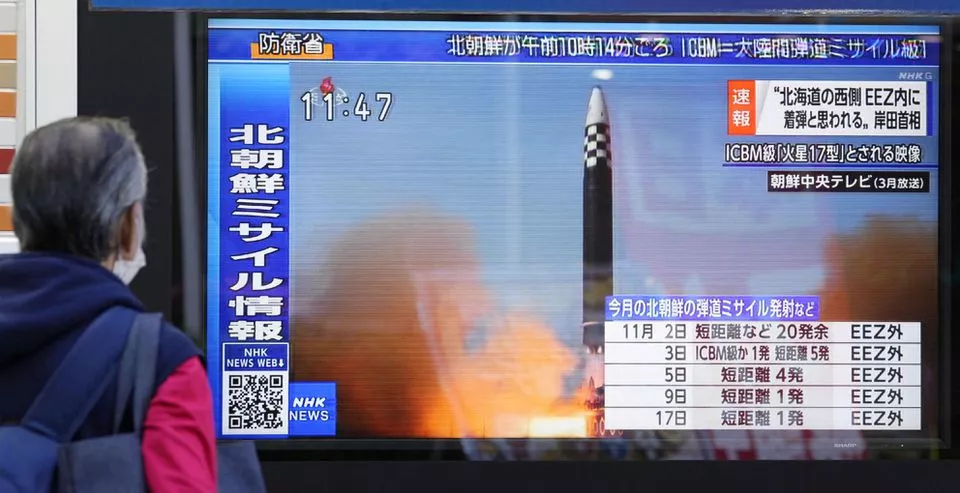 a passerby looks at a television screen showing a news report about north korea firing a ballistic missile in tokyo japan november 18 2022 mandatory credit kyodo via reuters a passerby looks at a television screen showing a news report about north korea firing a ballistic missile in tokyo japan november 18 2022 mandatory credit kyodo via reuters