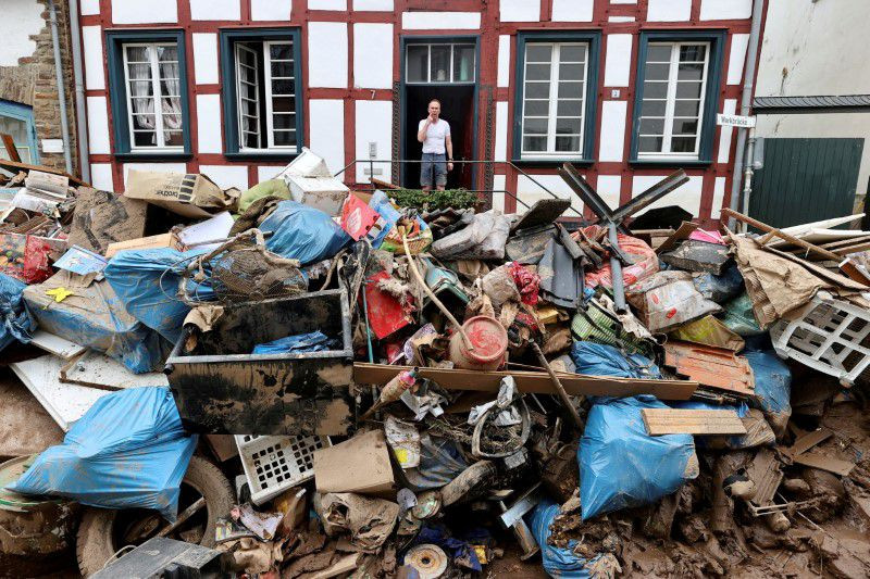 a man looks on outside a house in an area affected by floods caused by heavy rainfall in bad muenstereifel germany july 19 2021 reuters