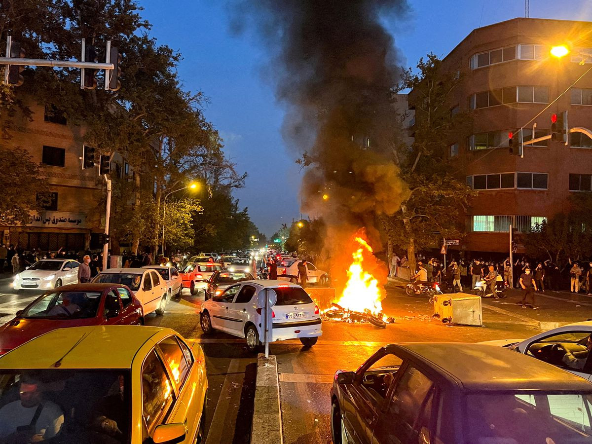 a police motorcycle burns during a protest over the death of mahsa amini a woman who died after being arrested by the islamic republic s morality police in tehran iran september 19 2022 wana west asia news agency via reuters