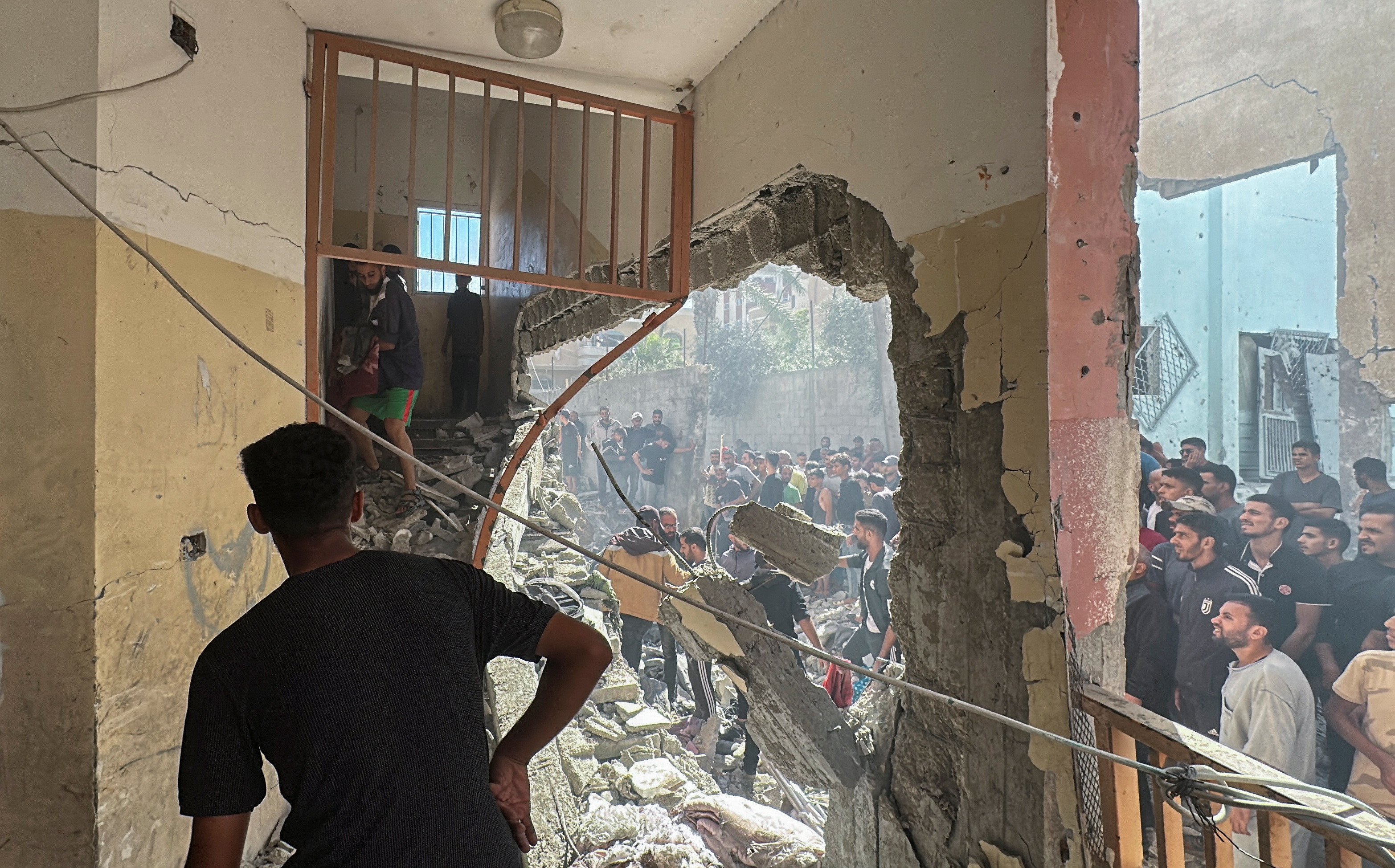 palestinians inspect the site of an israeli strike on a school sheltering displaced people amid the israel hamas conflict in nuseirat in the central gaza strip on october 24 2024 photo reuters